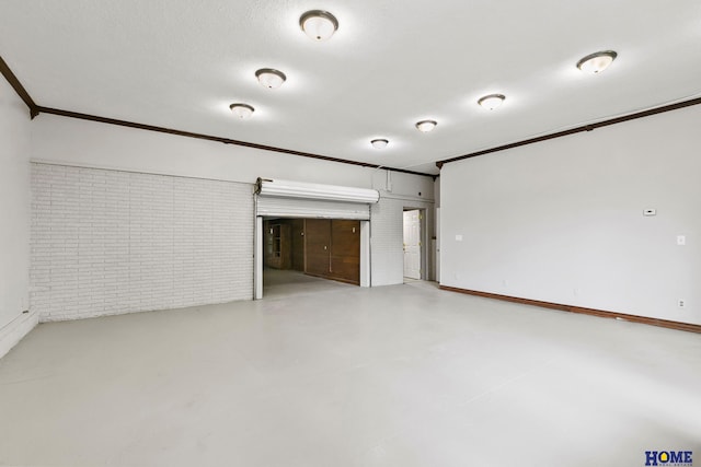 interior space featuring brick wall, finished concrete floors, and crown molding