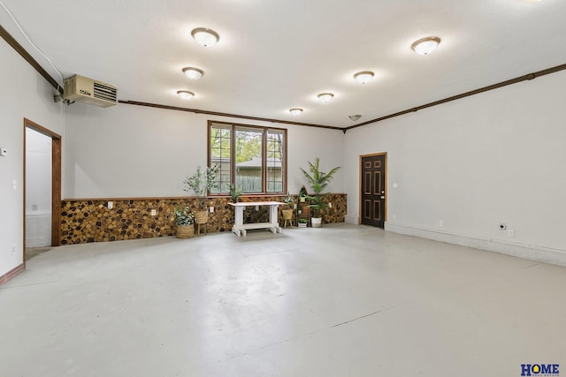 empty room with concrete floors and ornamental molding