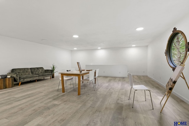unfurnished dining area featuring baseboards, light wood-style flooring, and recessed lighting