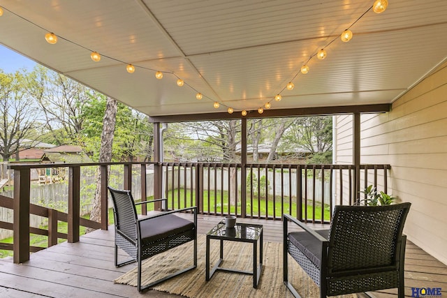 wooden deck with fence and outdoor lounge area