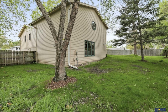 view of home's exterior featuring a yard and a fenced backyard