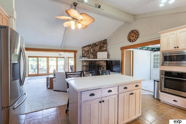 S-1129 Platte Shore Dr, Fremont, NE 68025 - kitchen with stainless steel appliances, open floor plan, light brown cabinetry, and tile patterned flooring