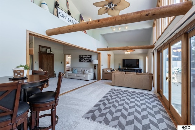 S-1129 Platte Shore Dr, Fremont, NE 68025 - living area featuring a ceiling fan, light carpet, and high vaulted ceiling