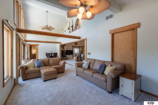 S-1129 Platte Shore Dr, Fremont, NE 68025 - carpeted living room featuring high vaulted ceiling, a ceiling fan, beamed ceiling, and baseboards