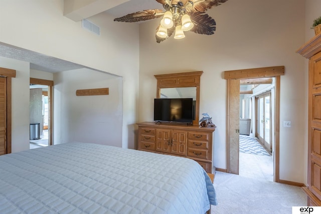 S-1129 Platte Shore Dr, Fremont, NE 68025 - bedroom featuring a towering ceiling, multiple windows, light carpet, a ceiling fan, and baseboards