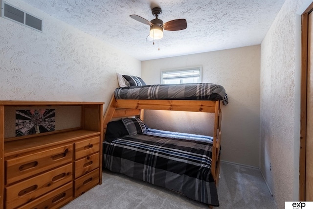 S-1129 Platte Shore Dr, Fremont, NE 68025 - carpeted bedroom featuring a textured wall, a textured ceiling, and a ceiling fan