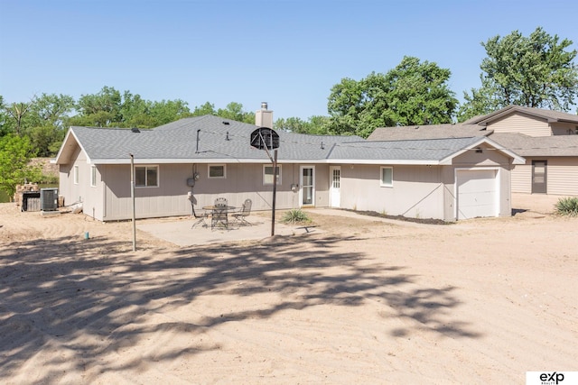 S-1129 Platte Shore Dr, Fremont, NE 68025 - view of front of home featuring central AC, a chimney, and a garage