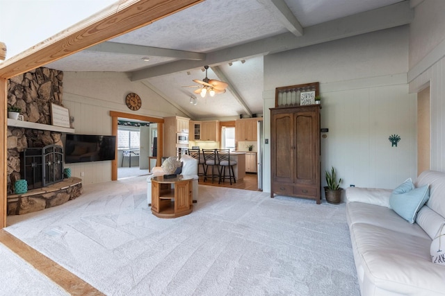 S-1129 Platte Shore Dr, Fremont, NE 68025 - living area featuring light carpet, a fireplace, and a ceiling fan