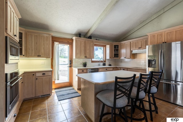 S-1129 Platte Shore Dr, Fremont, NE 68025 - kitchen with appliances with stainless steel finishes, a sink, dark tile patterned floors, backsplash, and a textured ceiling