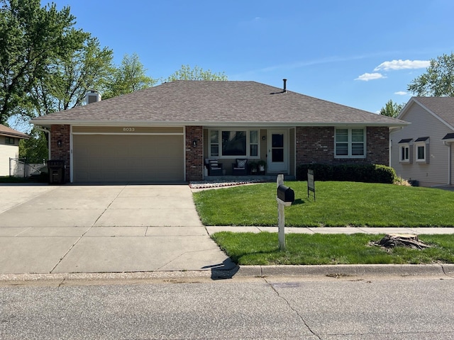 ranch-style house featuring driveway, brick siding, a garage, a front yard, and a porch