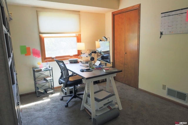 carpeted office space with baseboards and visible vents