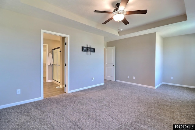 unfurnished bedroom featuring ensuite bathroom, carpet, and baseboards