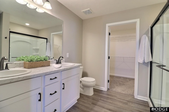 bathroom featuring a shower stall and a sink