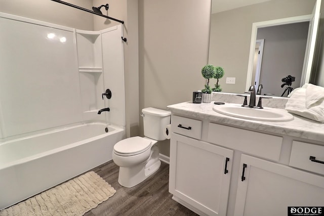 full bathroom with toilet, baseboards, vanity, tub / shower combination, and wood finished floors