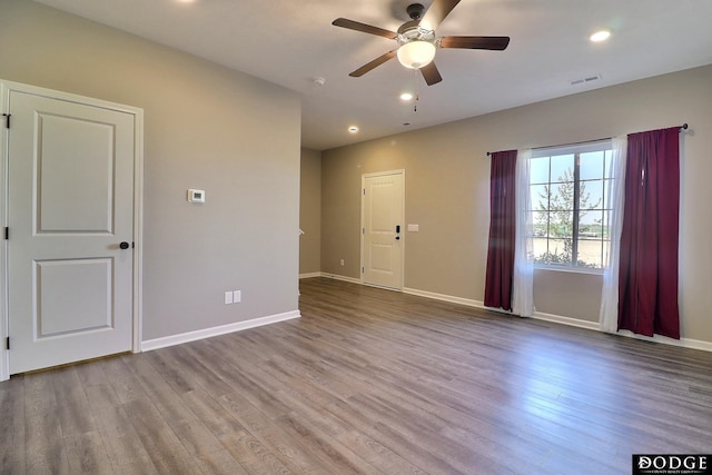 spare room with recessed lighting, baseboards, ceiling fan, visible vents, and wood finished floors