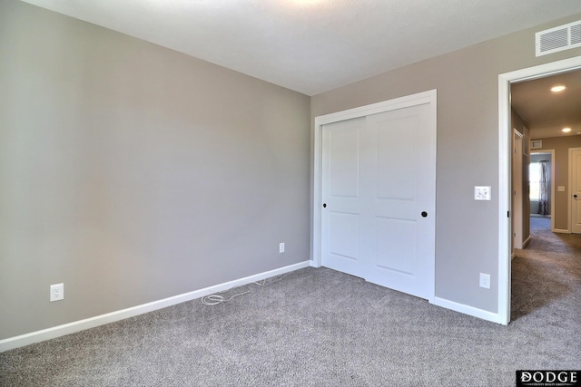 unfurnished bedroom featuring carpet, visible vents, and baseboards