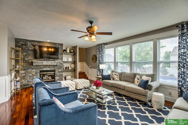 living room featuring stairs, wainscoting, ceiling fan, and hardwood / wood-style flooring