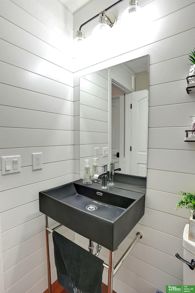 bathroom with wood walls