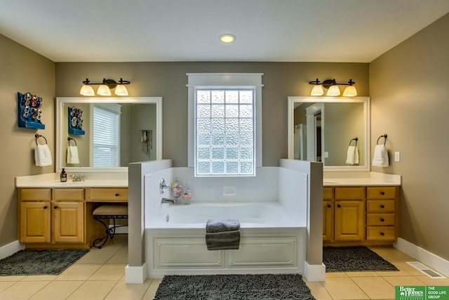 full bathroom featuring vanity, baseboards, a bath, and tile patterned floors