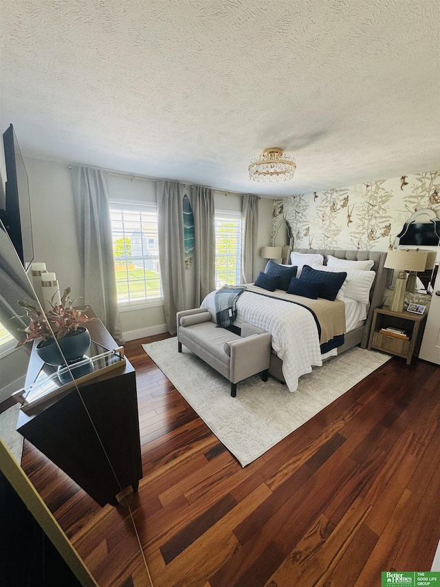bedroom featuring a textured ceiling and dark wood-style floors