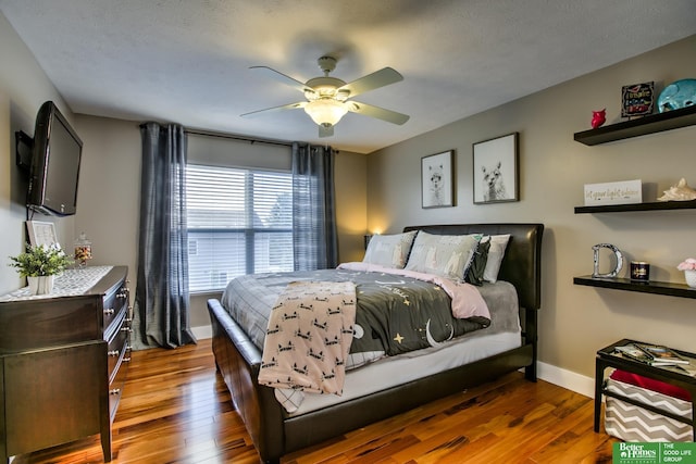 bedroom with hardwood / wood-style flooring, baseboards, and a ceiling fan