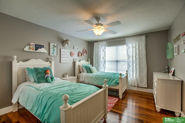 bedroom featuring ceiling fan, hardwood / wood-style flooring, and baseboards