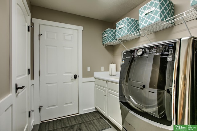 washroom featuring washer / dryer, cabinet space, and dark colored carpet