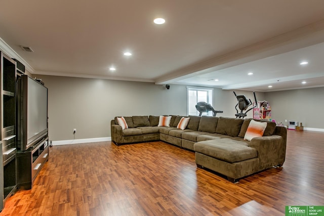 living area with wood finished floors, crown molding, visible vents, baseboards, and recessed lighting