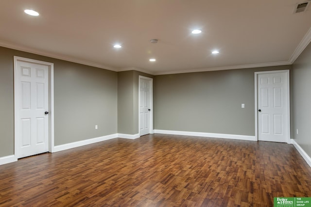 unfurnished room featuring visible vents, dark wood-style flooring, baseboards, and ornamental molding