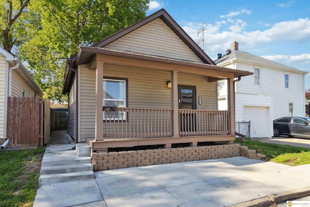 view of front of property featuring covered porch and a garage