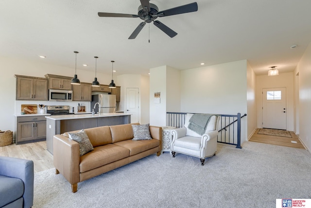 living area featuring baseboards, a ceiling fan, and recessed lighting