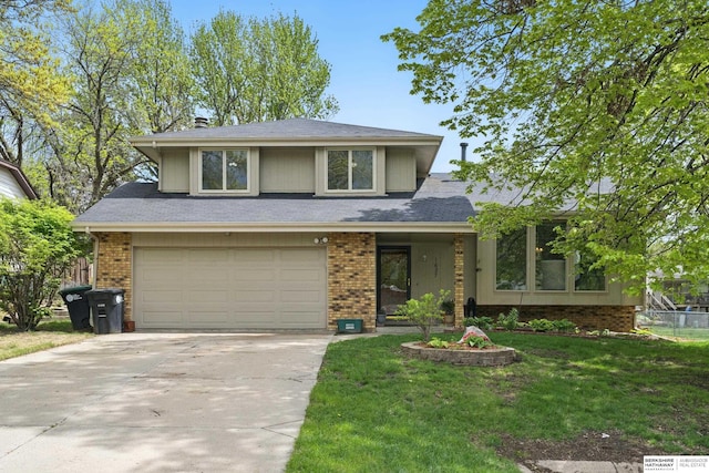 view of front of property featuring fence, brick siding, driveway, a garage, and a front lawn