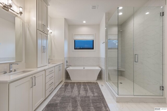 501 S 243rd St, Waterloo, NE 68069 - bathroom with a stall shower, marble look tile flooring, a freestanding tub, double vanity, and recessed lighting