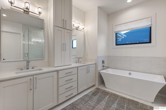 501 S 243rd St, Waterloo, NE 68069 - full bath featuring double vanity, a shower stall, a soaking tub, and recessed lighting