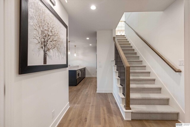 501 S 243rd St, Waterloo, NE 68069 - stairs with recessed lighting, wood finished floors, and baseboards