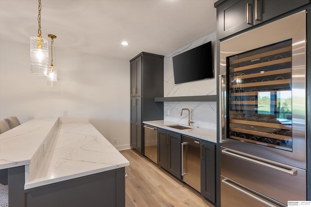 501 S 243rd St, Waterloo, NE 68069 - kitchen with stainless steel dishwasher, a sink, wine cooler, a peninsula, and light wood-style floors