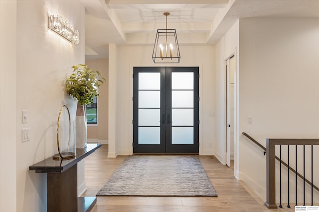 501 S 243rd St, Waterloo, NE 68069 - foyer entrance with light wood finished floors, french doors, a raised ceiling, baseboards, and a chandelier