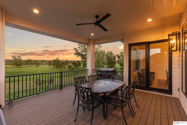 501 S 243rd St, Waterloo, NE 68069 - deck at dusk with ceiling fan, outdoor dining space, and a lawn