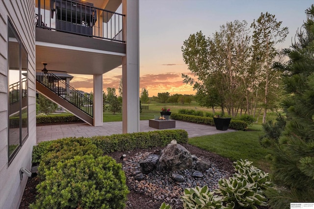 501 S 243rd St, Waterloo, NE 68069 - yard at dusk featuring stairs, a patio area, an outdoor fire pit, and a yard