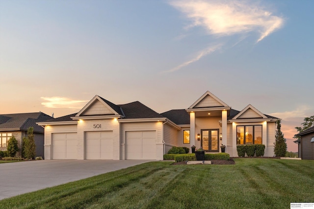 501 S 243rd St, Waterloo, NE 68069 - view of front of house with an attached garage, a front lawn, concrete driveway, and french doors