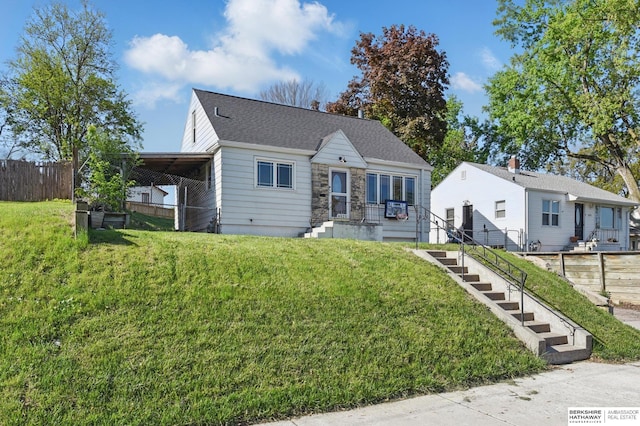 6523 Emmet St, Omaha, NE 68104 - bungalow-style home with stone siding, a front lawn, and fence