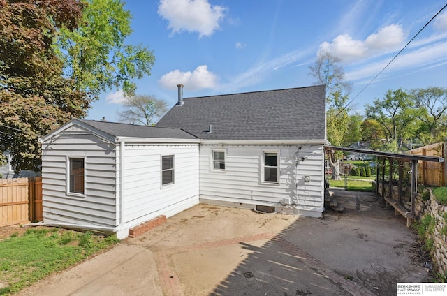 6523 Emmet St, Omaha, NE 68104 - rear view of property with a patio, a shingled roof, and fence