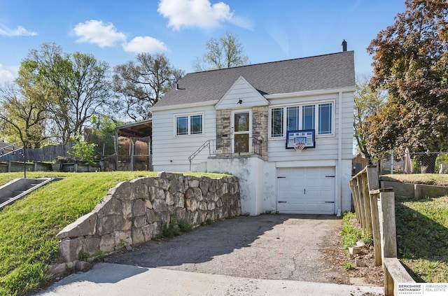 6523 Emmet St, Omaha, NE 68104 - view of front facade featuring roof with shingles, aphalt driveway, a garage, and fence