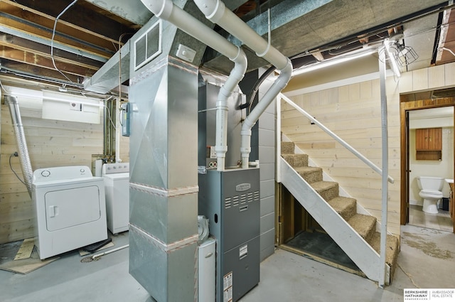 6523 Emmet St, Omaha, NE 68104 - unfinished below grade area featuring washer and clothes dryer, wood walls, visible vents, stairway, and heating unit