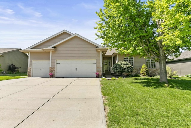 view of front facade with a front lawn, driveway, an attached garage, and stone siding
