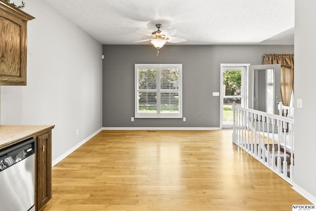 interior space with ceiling fan, a wealth of natural light, baseboards, and light wood finished floors