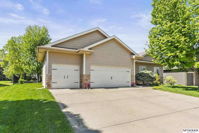 view of front of home with a garage, a front lawn, and driveway