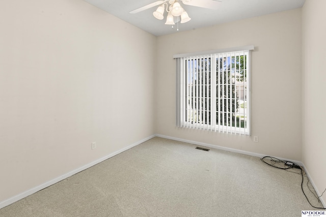 spare room featuring a ceiling fan, carpet flooring, visible vents, and baseboards