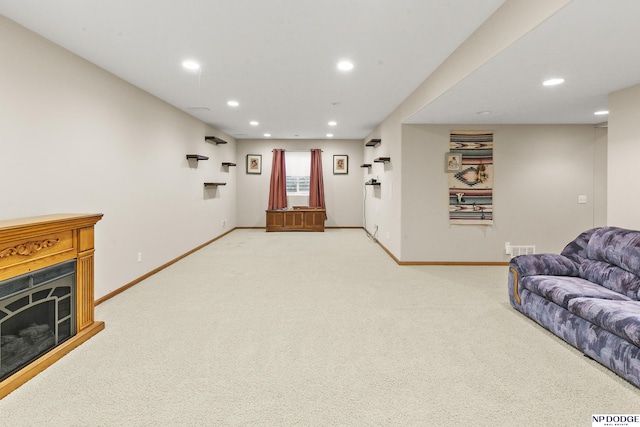 living area featuring baseboards, visible vents, recessed lighting, and light colored carpet