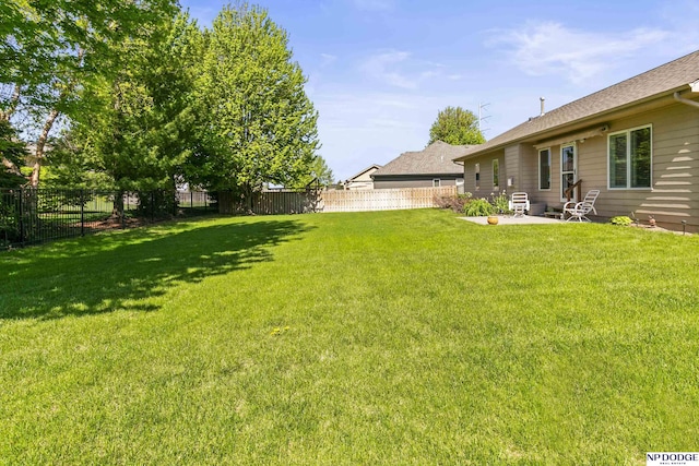 view of yard with a patio and a fenced backyard